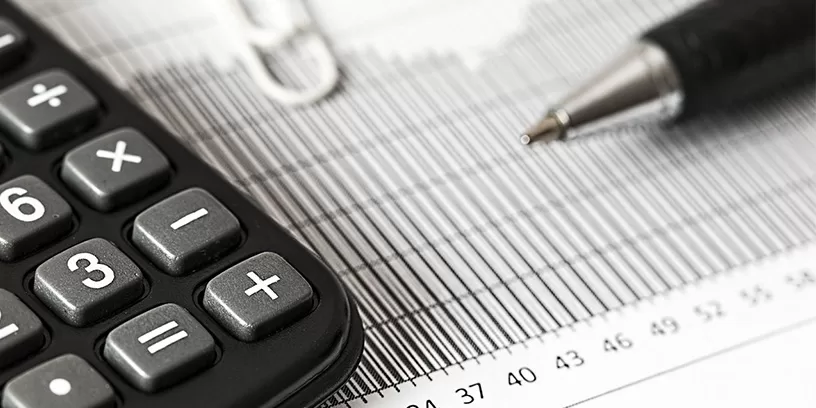 Calculator and pen on graph paper